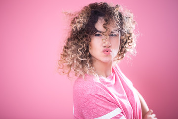 Portrait of young girl with pouted lips and with curly hair