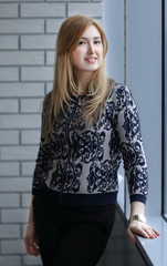 business woman standing near window in office