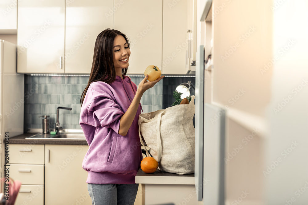 Poster Stylish woman with long dark hair feeling excited before making salad