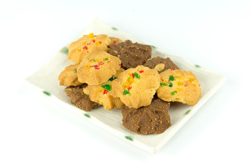 Many variety homemade cookies in plate isolated on white background.