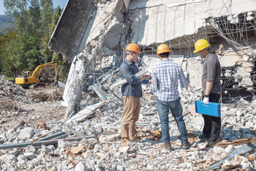 Engineer architect and worker operation control demolish old building.