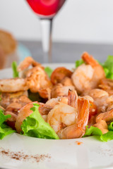 close-up of salad with king prawns on a plate on a light background