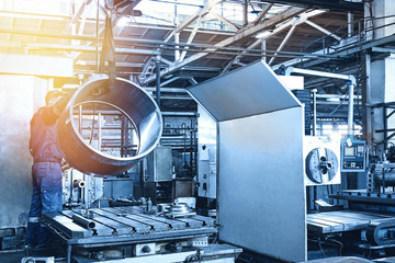 Metal industry: a worker prepares a valve part