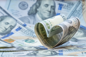 Heart from one hundred dollar bills USA. Money background. Copy space. Concept financial love and a gift for Valentine's Day.