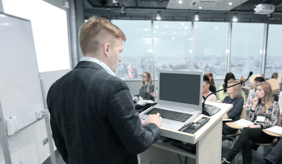 businessman makes a report to the employees of the company.