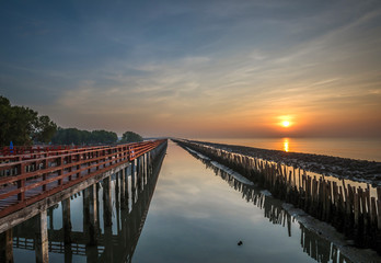 View of beautiful blue sea with bamboo fence protect sandbank from sea wave at Thailand.