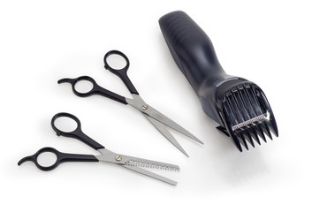 Electric hair clipper and two different professional hairdressers scissors