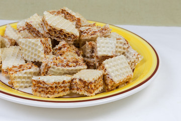 Sliced waffle layered cakes with caramel filling close-up
