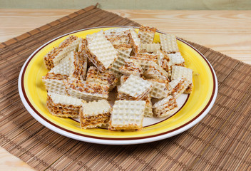 Sliced waffle layered cakes with caramel filling on dish