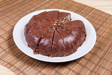 Sliced chocolate sponge cake on white dish