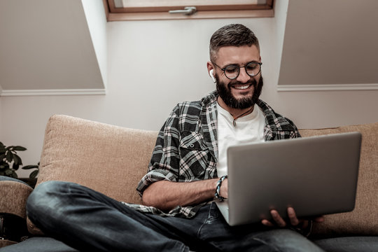 Cheerful nice man surfing the Internet website
