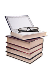 Old classic book and glasses on white background