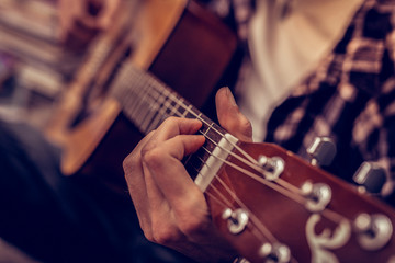 Close up of a male hand holding the guitar