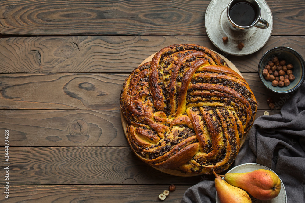 Sticker creative yeast dough cake stuffed with pear, chocolate and hazelnuts.