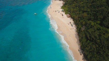 Aerial view of beautiful tropical island with white sand beach, hotels and tourists, Boracay, Puka shell beach. Tropical lagoon with turquoise water and white sand. Beautiful sea, beach, resort