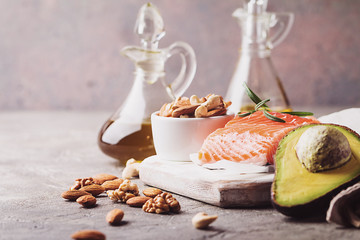 Healthy fats in nutrition - salmon, avocado, oil, nuts. Concept of healthy food