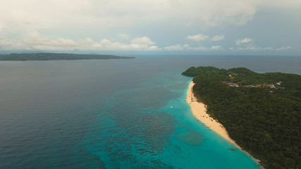 Aerial view of beautiful tropical island with white sand beach, hotels and tourists, Boracay, Puka shell beach. Tropical lagoon with turquoise water and white sand. Beautiful sea, beach, resort