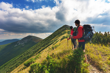 Fototapeta na wymiar A hiking trip in the mountains with a backpack.