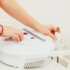 Closeup photo of professional cosmetologist working with laser peeling machine