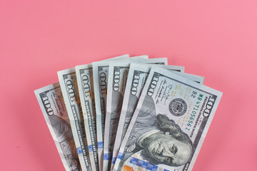Dollars. American paper money on a pink background