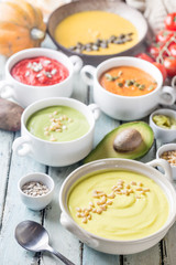 Variety of different colorful vegetable cream soups in a bowls. Concept of healthy eating or vegetarian food.