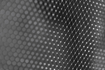 Shiny metal mesh dark background close-up