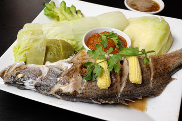 Snapper steamed with vegetables in Thailand.