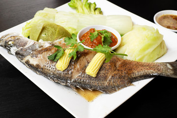 Snapper steamed with vegetables in Thailand.