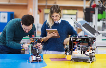 Young students of robotics working on project