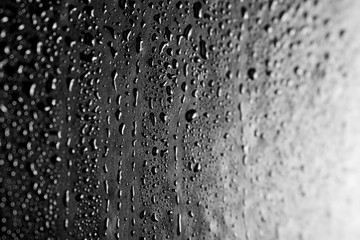 Drops of water on a dark glass texture background