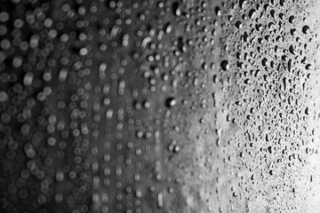Drops of water on a dark glass texture background