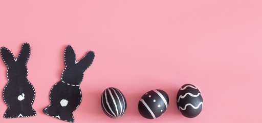 Easter composition with eggs and the Easter Bunny on a pink background