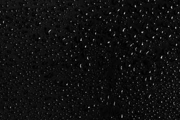 Drops of water on a dark glass texture background