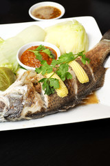 Snapper steamed with vegetables in Thailand.