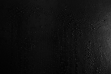 Drops of water on a dark glass texture background