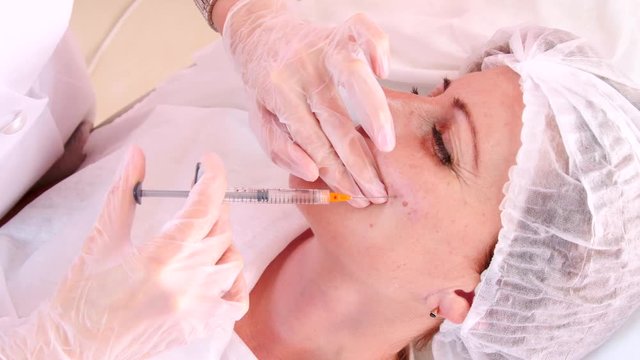 Correction tightening the face skin and cheeks with injections
