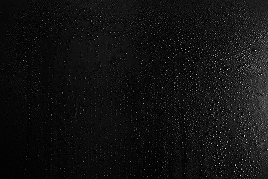 Drops of water on a dark glass texture background
