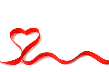 Isolated red satin ribbon in the shape of a heart on a white background with free space. The concept of love and Valentine Day