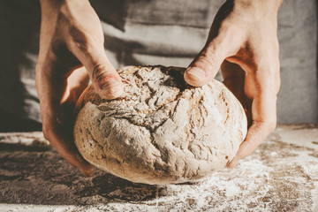 Baker or chef holding fresh made bread