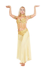 Naklejka premium Beautiful blonde bellydancer in golden-yellow costume over white background