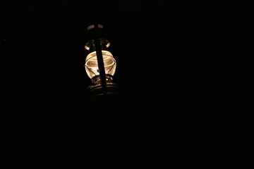 Fototapeta na wymiar Petrolium Lamp in front of a black background by night