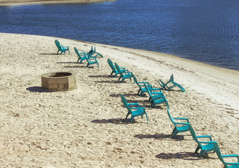 Fototapeta na wymiar Chairs on the sand of the beach