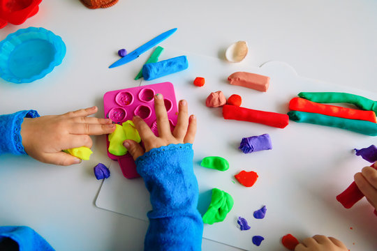 Child playing with clay molding shapes, kids crafts