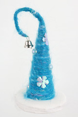 Handmade Christmas tree of blue threads with a bell