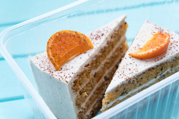 Two slices of delicious carrot cake in a container