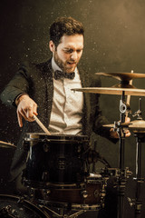 drummer plays in the hall poses
