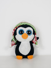 A plush penguin on a white background.