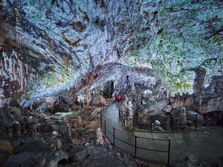 View of stalactites and stalagmites in an underground cavern - Postojna cave in Slovenia