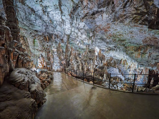 View of stalactites and stalagmites in an underground cavern - Postojna cave in Slovenia