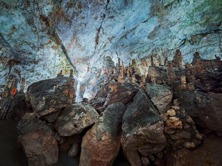 Fototapeta na wymiar View of stalactites and stalagmites in an underground cavern - Postojna cave in Slovenia